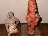 two figurines that are sitting on a wooden table