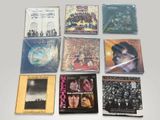 a lot of cds that are sitting on a table