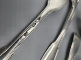 two spoons and a fork on a table