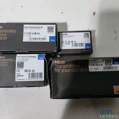 three boxes of electronic equipment sitting on top of a white table