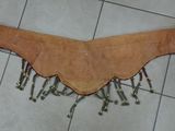 a piece of leather on the floor with screws attached to it