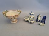 a bowl, cups, and figurines sitting on a table