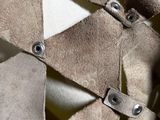 a close up of a piece of cloth with metal rivets on it