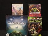 three video games sitting on top of each other on a table
