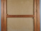 an old picture frame hanging on a wall in a room
