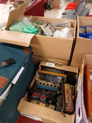 boxes of assorted items are stacked on a table in a room