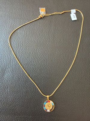 a gold necklace with a blue and yellow pendant on it