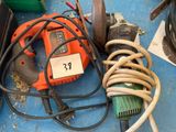 an orange and black electric drill sitting on top of a blue table
