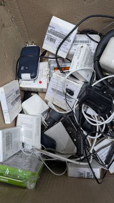 a cardboard box full of electronic devices and other items