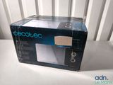 packaging for a microwave sitting on top of a table next to a window