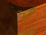 a close up of a wooden box with a metal handle
