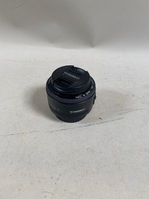 a black camera lens sitting on a white surface