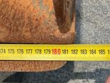 someone is measuring the length of a piece of metal with a tape