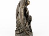 an image of a statue of an angel sitting on a rock