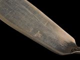 a close up of a knife on a black background