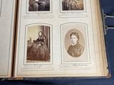 an old book with pictures of people sitting on a blue cloth
