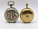 two gold and silver pocket watches with initials on them