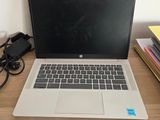 a laptop that is sitting on a desk with a charger