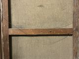 an old wooden frame with a painting hanging on it ' s side