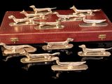 a lot of silver dog figurines in a red case