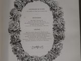 an open book with a picture of a wreath of roses on it