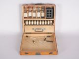 a wooden case with bottles and tools inside of it