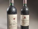 two bottles of wine sitting next to each other on a table