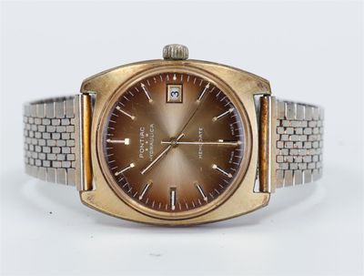 a gold watch with a brown face on a bracelet