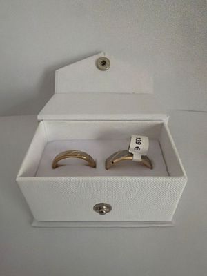 a box with two rings inside of it on a table