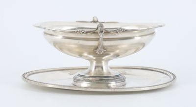 an antique silver plate with a dragonfly on it on a tray