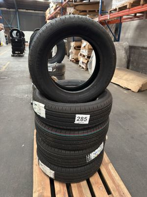 tires stacked on pallets in a warehouse with pallets in the background