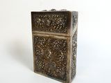 an antique brass box with a floral design on the front
