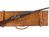 an old gun with a wooden case and a wooden handle