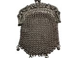 a close up of a metal purse on a white background