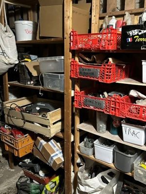 many baskets and bins on the shelves in the garage
