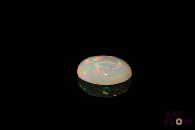 an image of a white fire opal in the dark