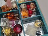 a drawer full of perfume bottles on a table