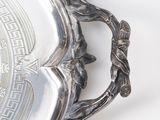 a silver tray with a design on it on a white surface