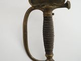 a gold colored sword on a white background