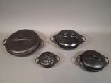 four pieces of silverware sitting on a white surface