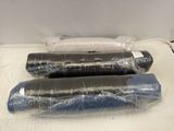 three rolls of toilet paper wrapped in plastic on a bed
