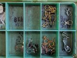 a green box filled with lots of different types of scissors