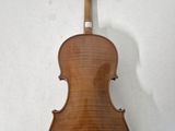 an old violin sitting on top of a white surface