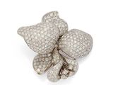 a white gold and diamond flower broochle