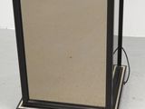 an image of a mirror with a black frame on a white floor
