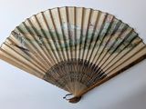 a fan that is hanging on the wall next to a wall