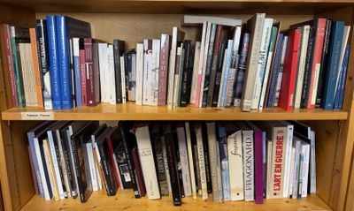 a book shelf with many books on it in a room