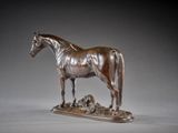 bronze statue of a horse standing on top of a pile of dirt