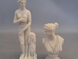 pair of white marble busturines of a woman and a man