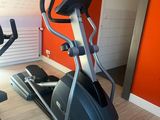 a gym room with a treadmill and a stationary bike